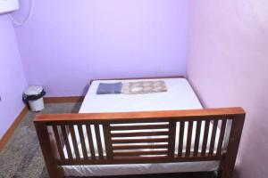a small room with a bed in a room at Villa Lune Home Stay in Puducherry +2 photos