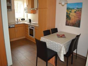 a kitchen and dining room with a table and chairs at Lindern Woodland Mansion in Werlte