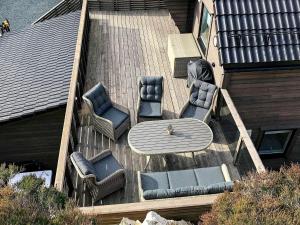 een luchtzicht op een terras met een tafel en stoelen bij 8 person holiday home in Urangsvåg in Ervik +42 foto's