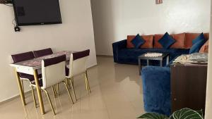 a living room with a couch and a table at Bel Appartement spacieux 3 pièces avec double salon Paisible & Proche de la Gare d'Agdal in Rabat