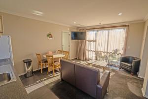 a living room with a table and a dining room at Mondello Kaikoura in Kaikoura