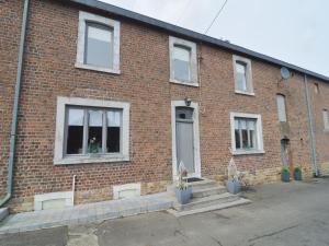 a brick building with a door and some potted plants at Luxury Pool Villa in Goesnes in Goesnes