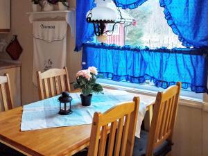 a dining room table with a vase of flowers on it at 6 person holiday home in Vevelstad-By Traum in Vevelstad