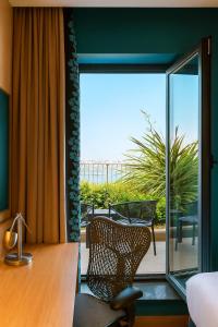 a desk and a chair in a room with a window at Dosso Dossi Hotels & SPA Golden Horn in Istanbul