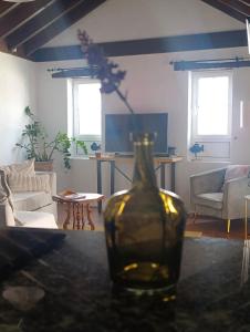 a living room with a vase on a table at Casa MaLuMi in Haría