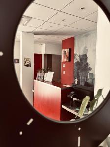 an office with a red desk and a red counter at Logis Hôtel Saint Martin in Orléans
