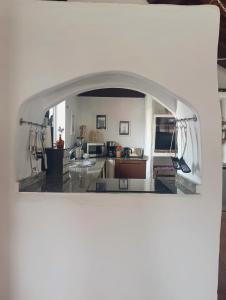 a kitchen with an archway in the middle of it at Casa MaLuMi in Haría +28 photos