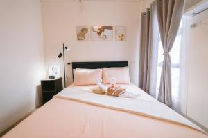 a bedroom with a bed with towels on it at Royal Oceancrest Eleanor suites in Lapu Lapu City