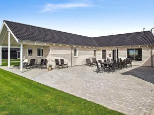 a patio with chairs and a table and a building at 5 star holiday home in Kappeln in Kappeln +8 photos