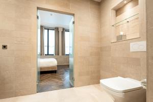 a bathroom with a toilet and a sink at Hôtel Perreyve - Jardin du Luxembourg in Paris +61 photos