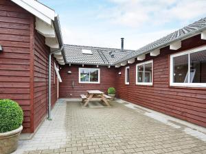 a picnic table in the courtyard of a house at Luxury Retreat in Nordborg - By Traum Ferienwohnungen in Nordborg