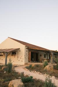 a house in the middle of a field at Helder Farm Studios in Odemira