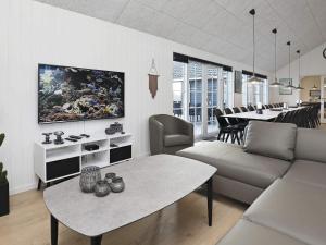 a living room with a couch and a table at 5 star holiday home in Frørup in Frørup