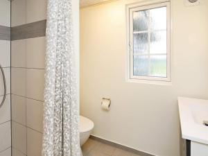 a bathroom with a toilet and a window at 5 star holiday home in Frørup in Frørup +33 photos