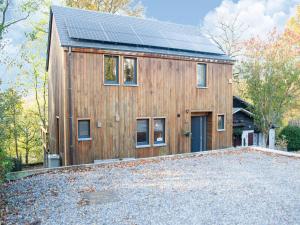 a wooden house with solar panels on it at Peaceful Durbuy Home & Garden in Durbuy