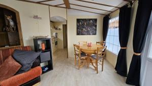 a room with a table and a dining room at Mobilehome in Weissenburg