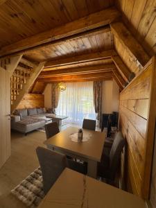 a living room with a table and a couch at Etno Villa Popovic in Žabljak