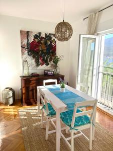 a dining room with a white table and chairs at Apartment Zahna in Njivice