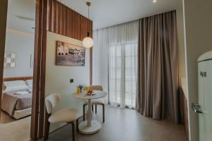 a small room with a table and a bed at Volaka Luxury Suites in Kos