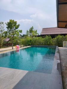 a swimming pool with a pink elephant in the middle at Ban Rim Nam Klongwan in Klong Wan +8 photos