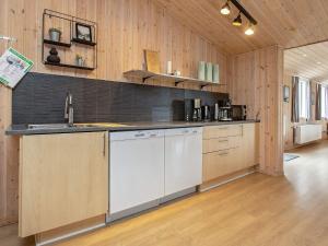a kitchen with wooden walls and a counter top at 5 star holiday home in Øster Assels in Øster Assels