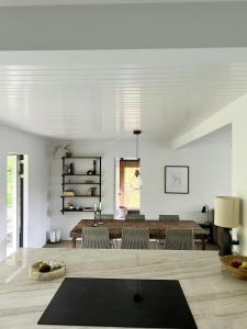 a living room with a table and chairs at Wooden House With Balinese Vibes At Maglesø 