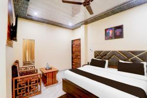 a bedroom with a bed and a fireplace at Super Hotel O Blue Heaven in Gorakhpur