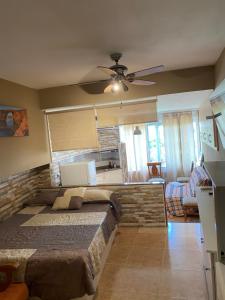 a bedroom with a large bed and a ceiling fan at Promar Playa 255 in La Pineda