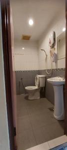 a bathroom with a toilet and a sink at RELAX HOTEL in Sungai Petani