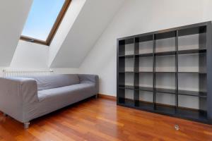 a living room with a couch and a book shelf at Urban Elegance Retreat in Bratislava