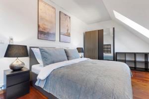a bedroom with a bed and a lamp on a table at Urban Elegance Retreat in Bratislava