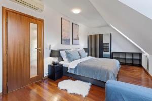 a bedroom with a bed and a stairway at Urban Elegance Retreat in Bratislava