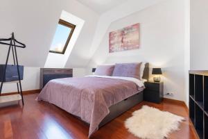 a bedroom with a bed and a tv and a rug at Urban Elegance Retreat in Bratislava