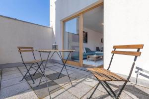 two chairs and a table on a patio at Urban Elegance Retreat in Bratislava +14 photos