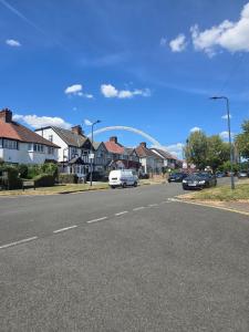 a street with houses and cars on the road at HolidayDreamHousesWembley in London