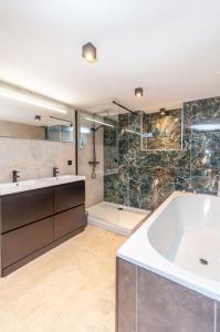 a bathroom with a large tub and a shower at Holiday Home in Antwerp in Antwerp +39 photos