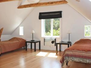 a attic bedroom with two beds and a window at 4 star holiday home in Söderåkra in Söderåkra