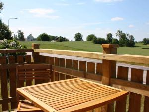 a wooden table and two chairs on a wooden fence at 4 star holiday home in Söderåkra in Söderåkra