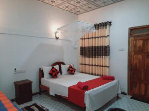 Ένα ή περισσότερα κρεβάτια σε δωμάτιο στο Sigiri Dasa Home stay