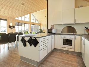 a kitchen with white cabinets and a stove top oven at 5 star holiday home in Odder in Odder