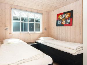 two beds in a room with a window at 5 star holiday home in Odder in Odder