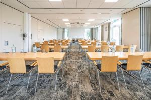 an empty room with tables and chairs at Best Western Plus Hotel Papenburg in Papenburg