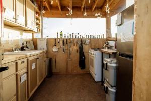 a large kitchen with wooden cabinets and a sink at Cedar Glamping Pod in Monticello +21 photos