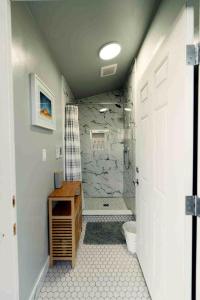 a bathroom with a shower and a toilet in it at Cedar Glamping Pod in Monticello