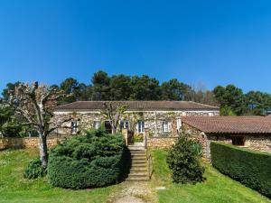 a stone house with a staircase in front of it at Forest View Home in Loubejac in Villefranche-du-Périgord