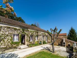 an old stone house with a tree in the yard at Forest View Home in Loubejac in Villefranche-du-Périgord +32 photos