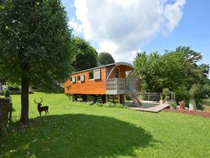 a tiny house with a deer standing in the grass at Wellness Escape in Bellevaux in Malmedy