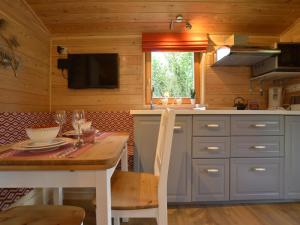 a kitchen with a table and a dining room at Wellness Escape in Bellevaux in Malmedy +32 photos
