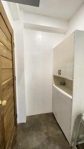 a white room with a door and a closet at Padayon Island Stay in General Luna +11 photos