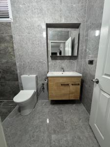 a bathroom with a toilet and a sink and a mirror at Köşem Motel Ören in Burhaniye